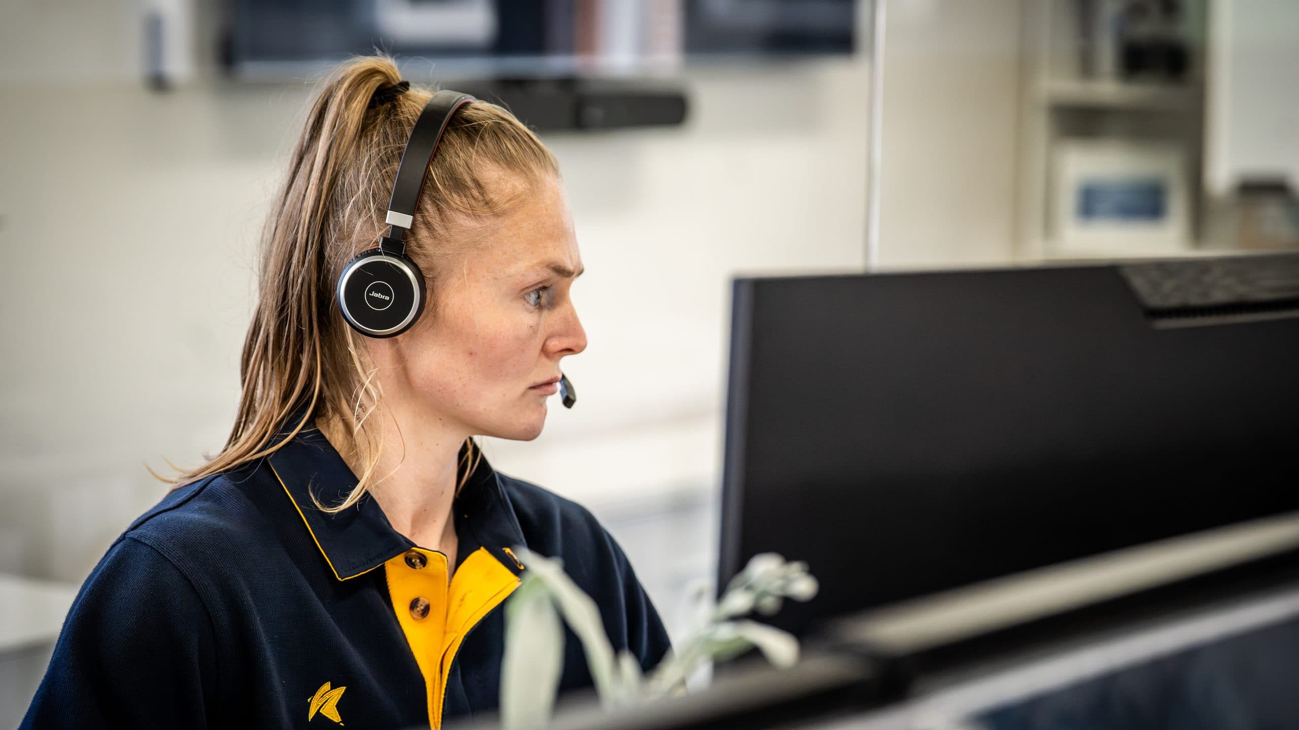 An SCCS support specialist wearing a headset at the service desk